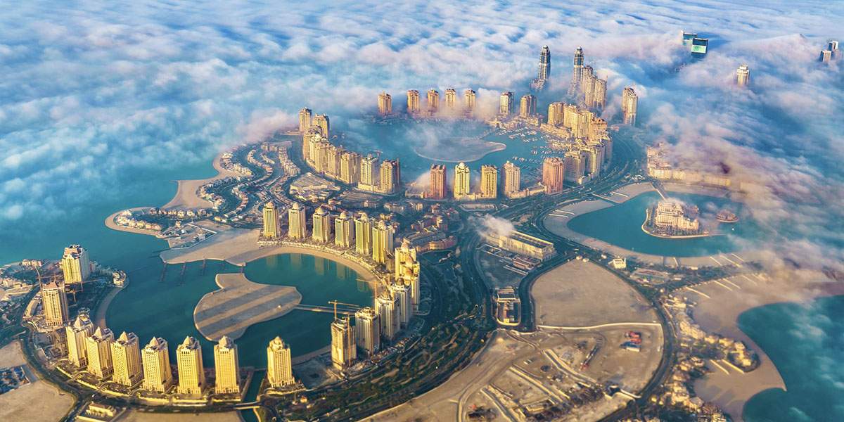 Banner image showing an aerial view of the pearl Qatar for the blog Qatar's evolving real estate market